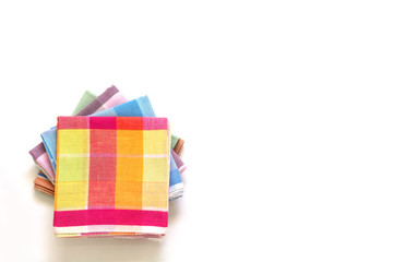 stack of folded handkerchiefs on white background, copy space