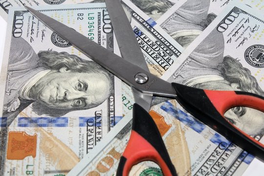 cissors cut money. background