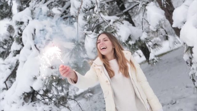 Girl With Sparklers On The forest At Snow