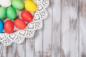 Colored easter eggs on a plate. Space for text.