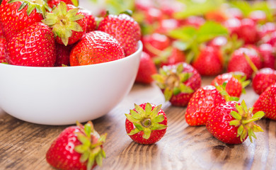 Fresh red strawberry on wood background