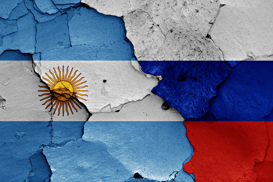 flags of Argentina and Russia painted on cracked wall