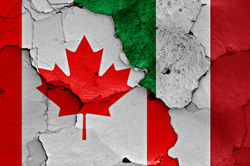 flags of Canada and Italy painted on cracked wall