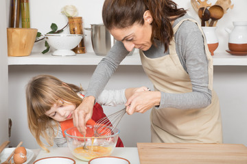 three years old child and woman, in teamwork, making and cooking a sponge cake at kitchen home,...