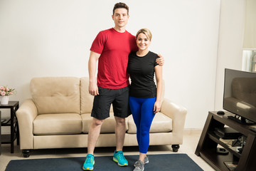 Fototapeta na wymiar Couple exercising together at home