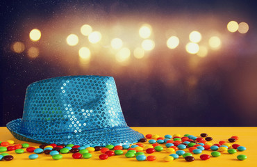 Blue shiny party Hat next to colorful candies