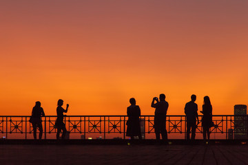 Fototapeta na wymiar Silhouette people at sunset in big city