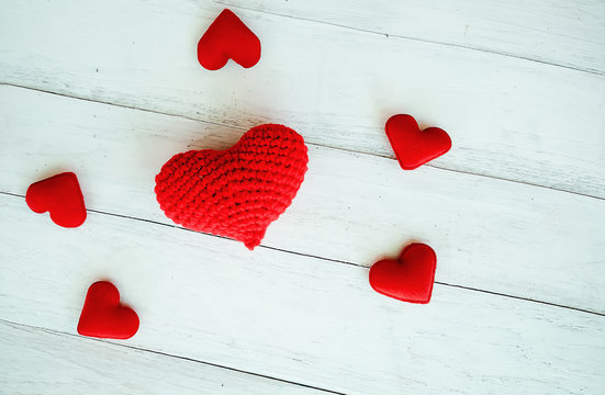 Love hearts hanging on rope on a white wooden background