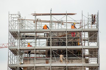 Fototapeta premium workers working on scaffolding