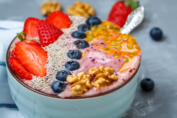 Breakfast smoothie berry bowl with chia, passion fruit and nuts. Clean eating, vegetarian, raw, detox, dieting concept