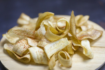 banana chips on a wooden plate
