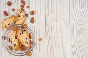 Fototapeta na wymiar Cookies with almonds and raisins on the old wooden table.