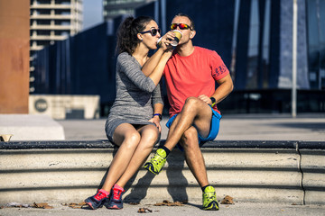 Young and attractive couple is sitting on bench and drinking mor © bint87