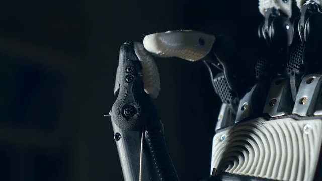 Robotic arm. Futuristic cyborg arm in action. 4K