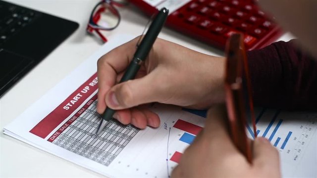 Accountant Man With Pen In Hand And Analyzes Stock Exchange Statistics