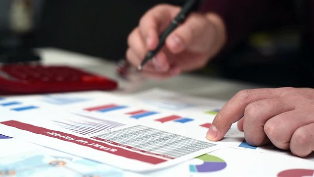 Trader Man Monitoring Stock Statistics. Close Up