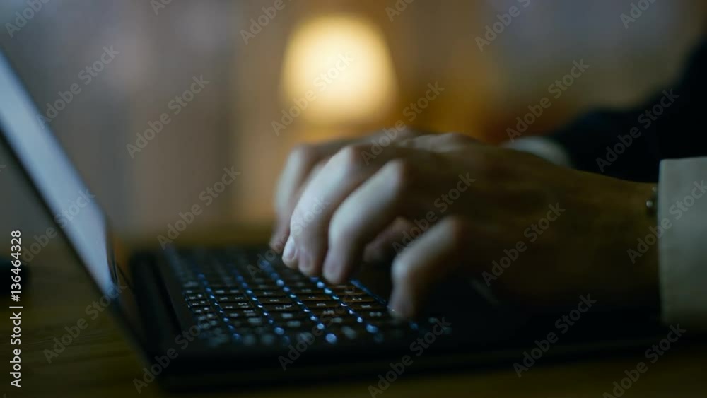 Poster close-up of man's hands typing on a laptop. in the background warm and homely atmosphere. shot on re