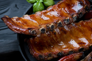 Close-up of baked pork ribs glazed in mix of honey and soy sauce