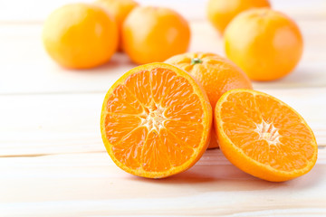 Fresh oranges cut on wooden background