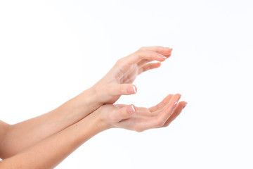 two women's hands are outstretched to the side and lying on top of one another with palms is isolated on a white background