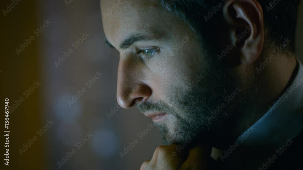 Poster close-up of a man's face working on a computer. he sits in a dark apartment. shot on red epic-w 8k h