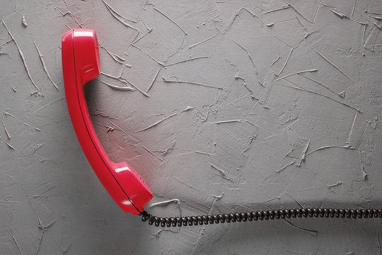 handset from landline phone on the background wall