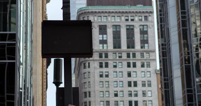Sign telling oncoming traffic to yield to pedestrians in downtown of city.
