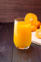 Orange juice on wooden background