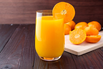 Orange juice on wooden background
