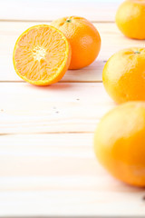 Fresh oranges cut on wooden background