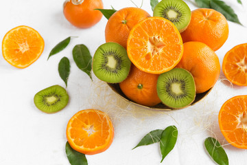 Fresh fruit tangerine, orange and kiwi close-up