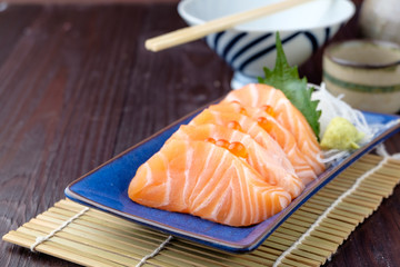 salmon sashimi on wooden background