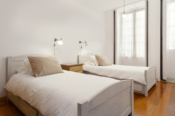 Fototapeta na wymiar Bright and Fresh Bedroom Suite with double beds