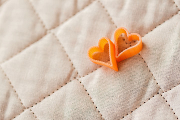 Romantic abstract picture, pasta in the form a heart, two pieces. Food background for Valentine's Day. Top view. With place  your text