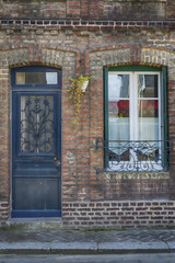 Port and old brick house window