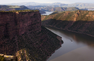 Scenic view of boat in river amidst mountains