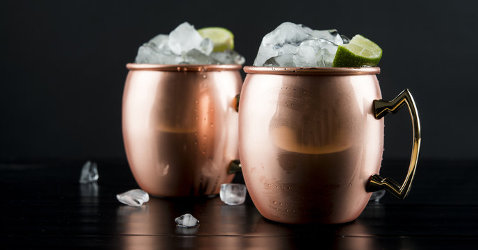 Close up of moscow mules on table against black background