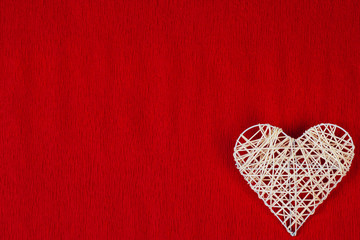 Fototapeta premium Woven heart on a red corrugated paper.