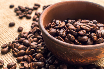 Coffee beans in wood bowl on white background