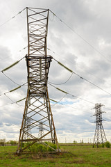 aerial power lines in a field on a cloudy day