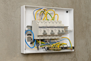 Circuit breakers in a plastic box on a wall