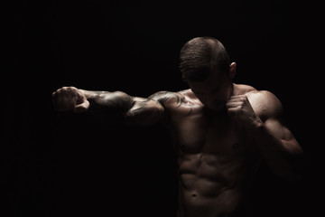 Fototapeta na wymiar Strong athletic man showes naked muscular body