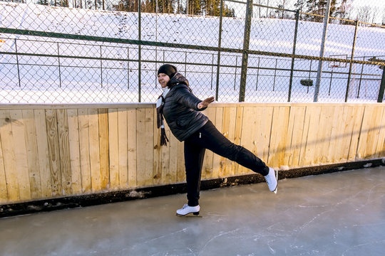 Girl skates at the rink in the winter time