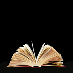 Open old Book on  black background, big data