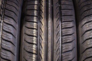 Symmetrical summer tires on the shelf at the tires store