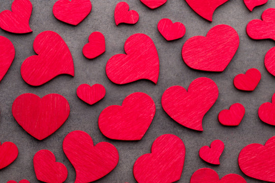 Red hearts on the wooden background.