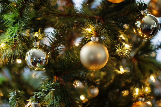 Close-up of ornaments and lights on Christmas tree