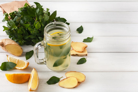 Natural detox lemonade smoothie ingredients on white wood background