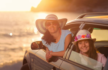 Mother with daughter travel by car on summer vacation selective