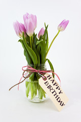 Happy Birthday tulips with tag in vase.